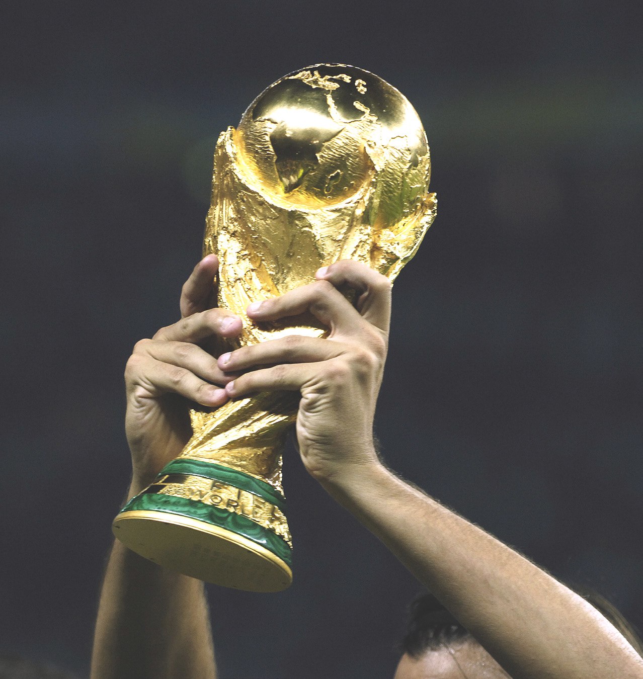 Hands raising the FIFA World Cup™ Trophy